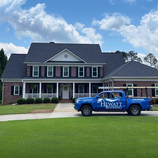 hewatt roofing truck infront of residential house